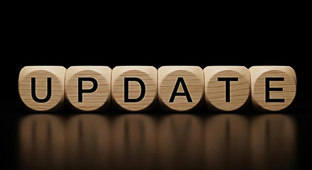 Wooden blocks spelling UPDATE in a dark environment symbolizing progress and improvement highlighting the importance of staying current and relevant in a dynamic world conveying a sense of advancement photo