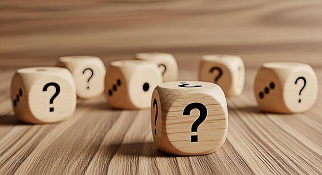 Wooden dice displaying question marks on a wooden surface representing uncertainty and the need for problemsolving in a challenging environment evoking a sense of curiosity and intellectual exploratio photo