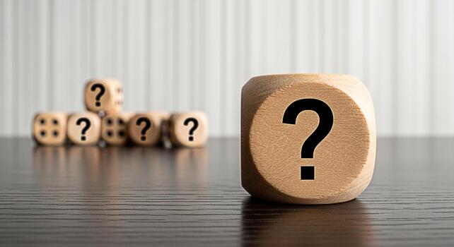 Wooden dice displaying question marks on a dark wooden surface representing uncertainty and the search for answers in a business or personal context creating a mood of curiosity and inquiry photo