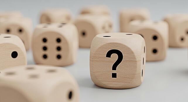 Wooden dice displaying a question mark among other dice on a neutral surface symbolizing uncertainty and decisionmaking in a game of chance reflecting a mood of curiosity and anticipation photo
