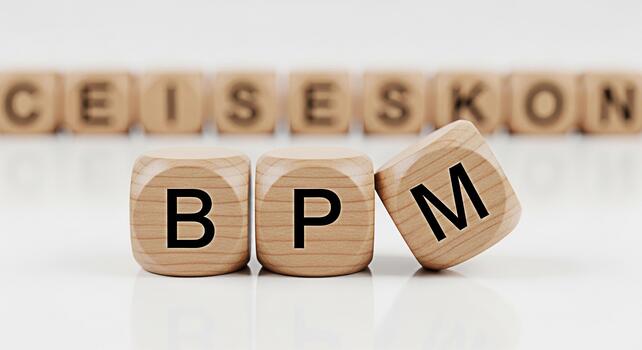 Wooden blocks spelling BPM on a reflective white surface representing business process management efficiency and optimization in a corporate environment conveying a sense of professionalism and strate photo