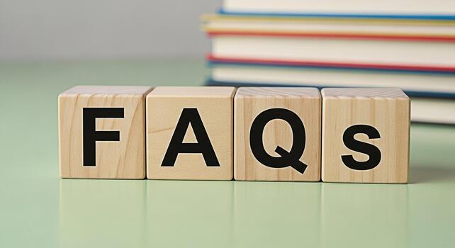 Wooden blocks spelling FAQs on a green surface representing information and support with a stack of books in the background conveying a sense of knowledge and assistance for customer service solutions photo
