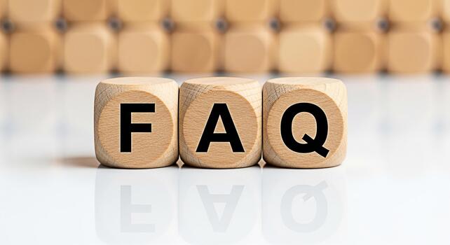 Wooden blocks displaying FAQ on a white reflective surface representing frequently asked questions and information creating a clear and accessible resource for customers and users promoting knowledge photo