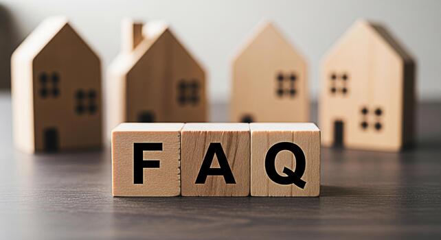 Wooden blocks spelling FAQ in front of miniature house models on a dark wooden table representing frequently asked questions about real estate and property investment in a simple informative way photo