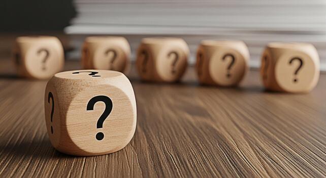 Wooden dice displaying question marks on a wooden surface representing uncertainty and the need for solutions in a challenging environment evoking curiosity and the search for answers photo