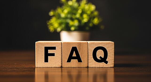 Wooden blocks displaying FAQ on a polished wooden surface with a blurred green plant in the background representing information and customer support in a simple and accessible manner photo