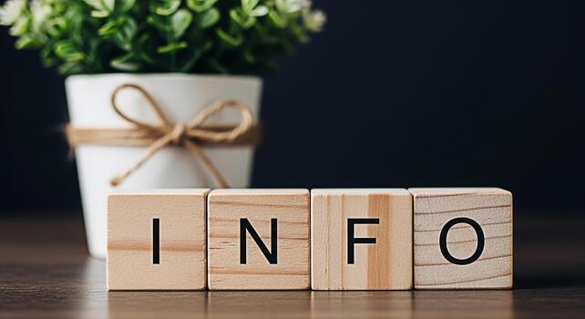 Wooden blocks spelling INFO on a dark wooden surface conveying essential information and knowledge with a potted plant in the background creating a calm and informative atmosphere photo