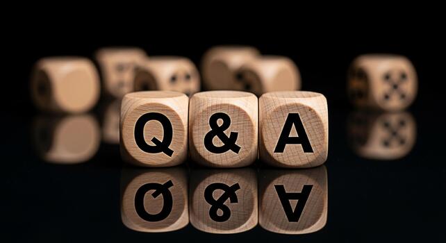 Wooden dice spelling out QA on a reflective black surface representing questions and answers in a business or educational setting fostering a mood of inquiry and knowledgeseeking photo