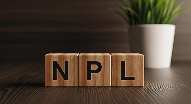 Wooden blocks spelling NPL displayed on a dark wooden surface symbolizing nonperforming loans in a financial setting creating a serious and professional atmosphere with a focus on risk management photo