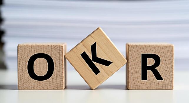 Wooden blocks spelling OKR on a white surface representing Objectives and Key Results in a business setting conveying a sense of focus and strategic planning for achieving goals and driving success photo