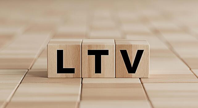 Wooden blocks displaying LTV on a wooden surface representing customer lifetime value emphasizing business strategy and financial planning in a neutral and professional setting photo