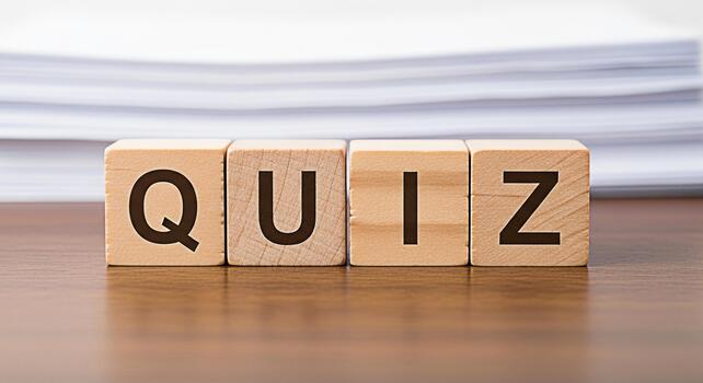 Wooden blocks spelling QUIZ on a wooden table with a stack of papers in the background representing a test challenge or knowledge assessment in an educational or corporate setting photo