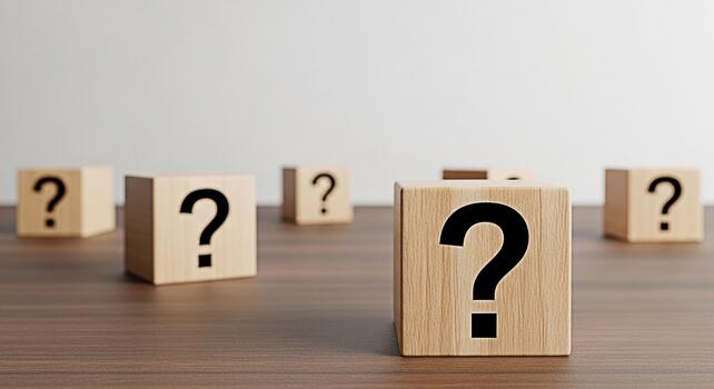 Wooden blocks displaying question marks on a wooden table symbolizing uncertainty and seeking answers in a minimalist setting creating a thoughtful and inquisitive mood photo