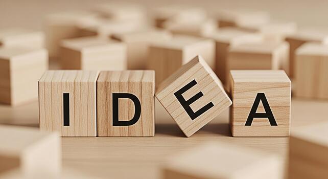 Wooden blocks spelling IDEA resting on a table symbolizing creativity and innovation in a neutraltoned minimalist setting conveying a sense of inspiration and problemsolving for business and personal photo