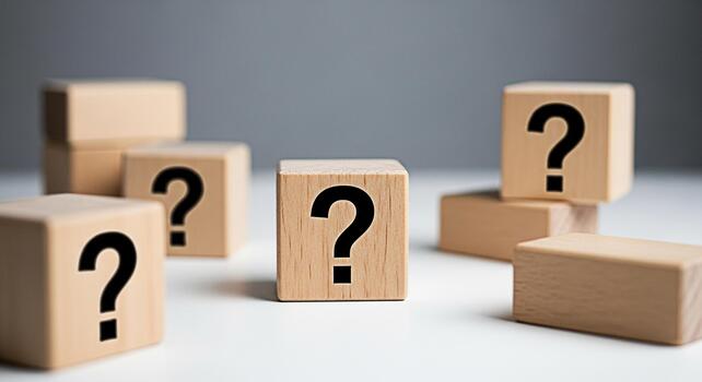 Wooden blocks displaying question marks on a white surface representing uncertainty and the search for answers in a minimalist and conceptual setting evoking curiosity and problemsolving photo