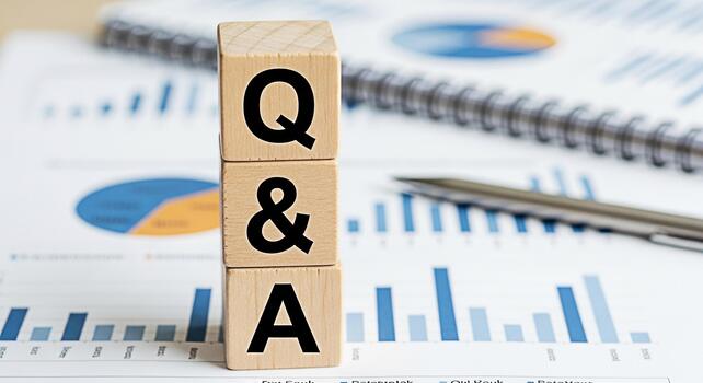 Wooden blocks displaying QA on a financial report with a pen and notebook representing questions and answers knowledge sharing and problemsolving in a business environment photo