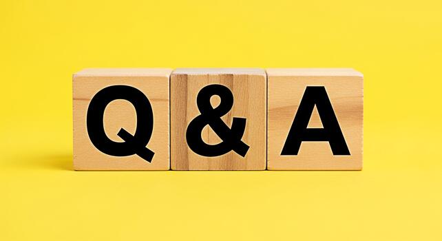 Wooden blocks spelling out Q A on a bright yellow background representing questions and answers knowledge sharing and information exchange in a simple and clear visual concept photo