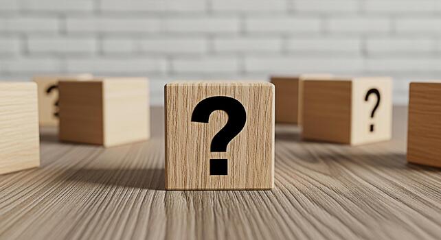 Wooden blocks displaying question marks on a wooden surface against a white brick wall representing uncertainty problemsolving and the search for answers in a clean and minimalist environment photo
