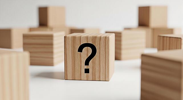 Wooden cube displaying a question mark symbol on a white surface surrounded by other blurred cubes representing uncertainty problemsolving and the search for answers in a minimalist setting photo