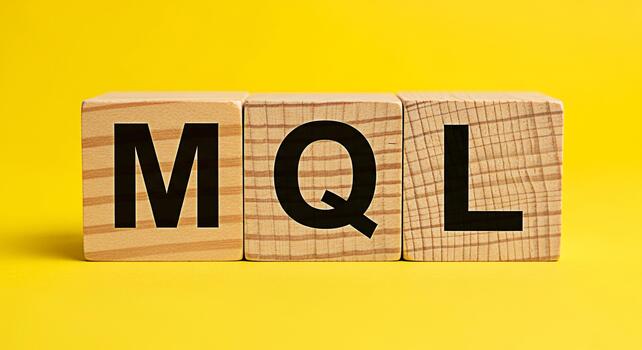 Wooden blocks displaying MQL acronym on a vibrant yellow background representing marketing qualified leads and business strategy conveying a message of clarity and focus in a studio setting photo