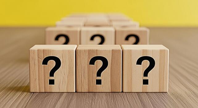 Wooden blocks displaying question marks in a bright studio setting symbolizing uncertainty inquiry and the search for answers in business education and personal development contexts photo