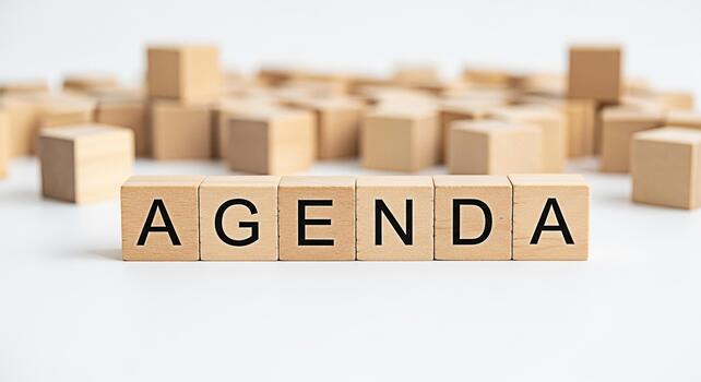 Wooden blocks spelling Agenda on a white surface symbolizing planning and organization in a business environment conveying a sense of structure and control for effective time management photo