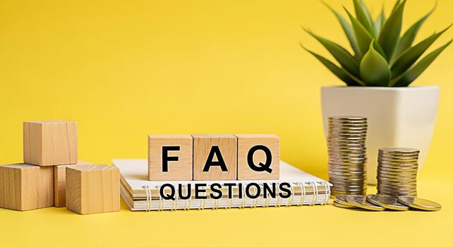 Wooden blocks displaying FAQ questions on a notepad with stacked coins and a potted plant against a vibrant yellow background symbolizing financial queries and information resources photo
