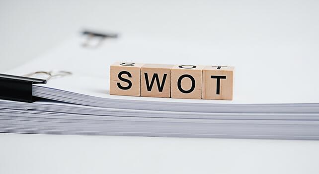 SWOT analysis blocks resting on a stack of documents in a bright minimalist office setting representing strategic business planning and assessment for growth and success photo