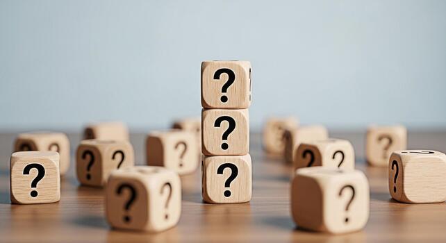 Stacked wooden blocks displaying question marks on a wooden surface representing uncertainty and the need for answers in a business or educational setting creating a sense of curiosity and challenge photo