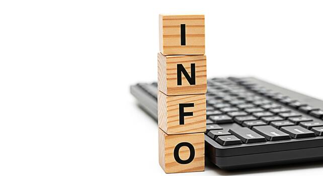 Wooden blocks spelling INFO sitting near a black keyboard on a white background conveying information knowledge and data processing in a modern clean and minimalist setting photo