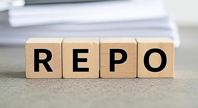 Wooden blocks spelling REPO on a gray surface representing repurchase agreements in a financial setting conveying concepts of finance investment and economic transactions with a neutral and informativ photo
