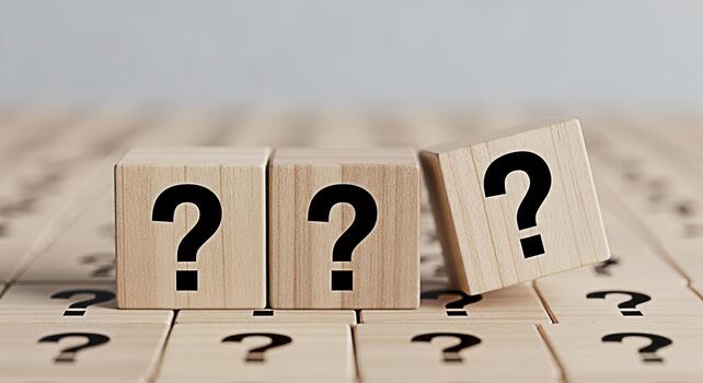 Wooden cubes displaying question marks on a textured surface symbolizing uncertainty and the search for answers in a complex problemsolving environment creating a mood of curiosity and inquiry photo