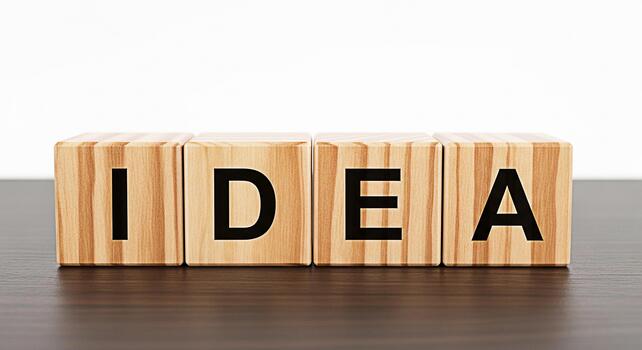 Wooden blocks spelling out IDEA on a dark wooden table symbolizing creativity and innovation in a bright minimalist setting fostering a sense of inspiration and problemsolving for business and educati photo