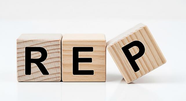 Wooden blocks spelling REP on a white surface representing repetition and practice symbolizing learning and improvement through consistent effort and dedication in a clean minimalist setting photo