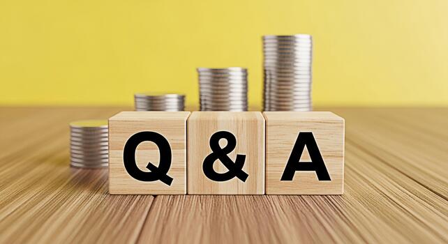Wooden blocks displaying Q A with stacks of coins on a wooden surface against a yellow background representing financial questions and answers investment advice and money management concepts photo