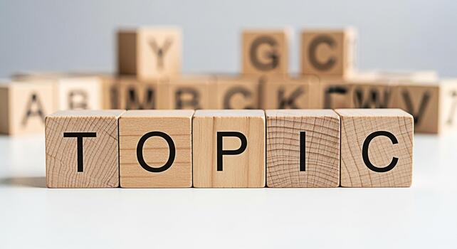 Wooden blocks spelling out TOPIC on a white surface surrounded by other letter blocks representing a focused discussion and the importance of clear communication in a learning environment photo