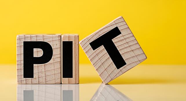 Wooden blocks spelling PIT on a bright yellow background with the letter T falling symbolizing challenges and adversity in business and life creating a sense of instability and risk photo