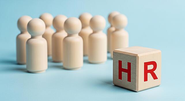 Wooden figures standing near a HR block on a blue background representing human resources management recruitment and the importance of employees in a company creating a sense of teamwork and unity photo