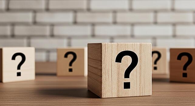 Wooden cubes displaying question marks on a wooden surface against a brick wall representing uncertainty problemsolving and the search for answers in a conceptual and thoughtprovoking composition photo