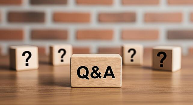 Wooden blocks displaying QA and question marks on a wooden table against a brick wall representing problemsolving knowledge acquisition and the importance of asking questions for clarity and understan photo