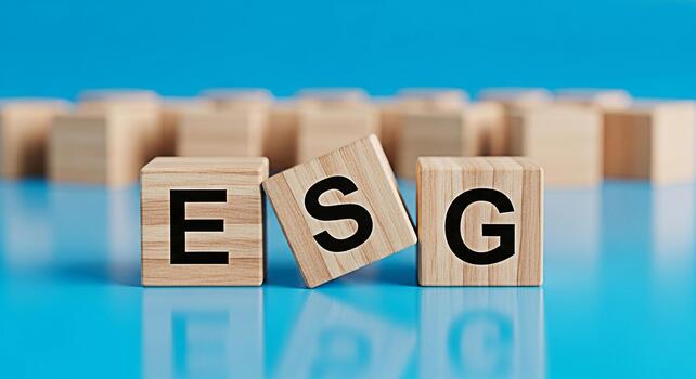 Wooden blocks displaying ESG letters on a blue surface representing environmental social and governance principles promoting sustainable and responsible business practices in a corporate setting photo