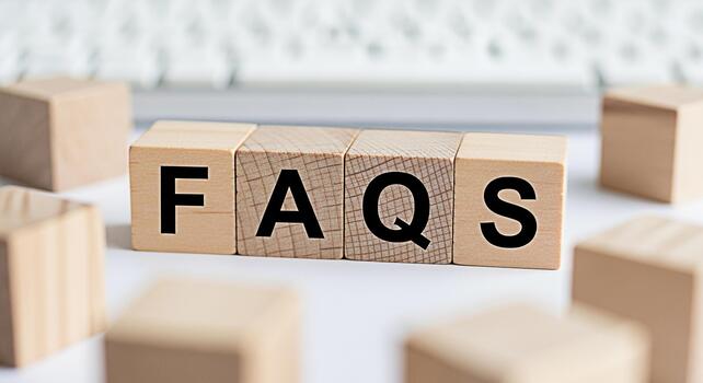 Wooden blocks spelling FAQs on a white surface surrounded by other blocks representing frequently asked questions and providing information creating a sense of clarity and support photo