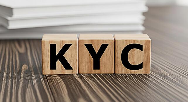 Wooden blocks displaying KYC on a wooden table in a bright office setting representing the concept of Know Your Customer compliance and regulatory requirements for financial institutions and businesse photo