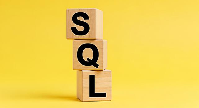 Stacked wooden blocks displaying SQL on a bright yellow background representing database management and data querying conveying a sense of organization and structured information photo