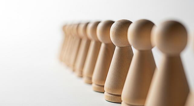Aligned wooden pawn figures standing in a row on a white surface symbolizing unity teamwork and strategic planning for business success and leadership development in a competitive environment photo
