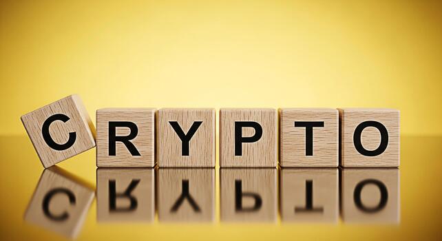 Wooden blocks spelling CRYPTO on a reflective surface against a golden background symbolizing the dynamic and innovative world of cryptocurrency and blockchain technology with a focus on investment an photo