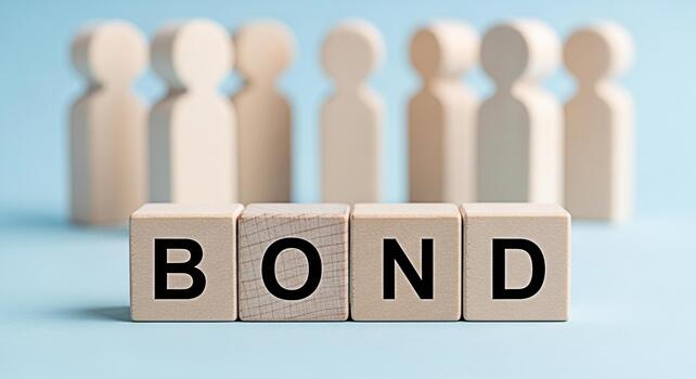 Wooden figures standing behind the word BOND spelled out with wooden blocks on a blue surface representing connection unity and the importance of strong relationships in a community setting photo