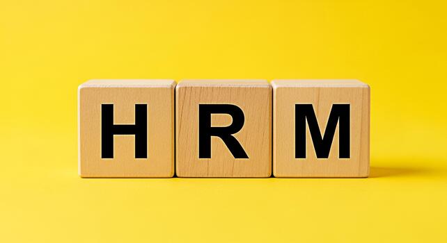 Wooden blocks displaying HRM on a bright yellow background representing Human Resources Management symbolizing business strategy and organizational structure for effective workforce management and emp photo