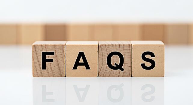 Wooden blocks spelling FAQs on a white reflective surface presenting a clear and concise information resource for customers seeking answers to common questions promoting clarity and customer satisfact photo