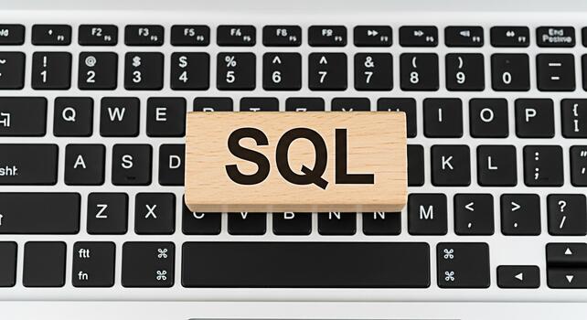 Wooden block displaying SQL on a laptop keyboard representing database management and programming concepts in a modern tech environment symbolizing data analysis and information technology photo